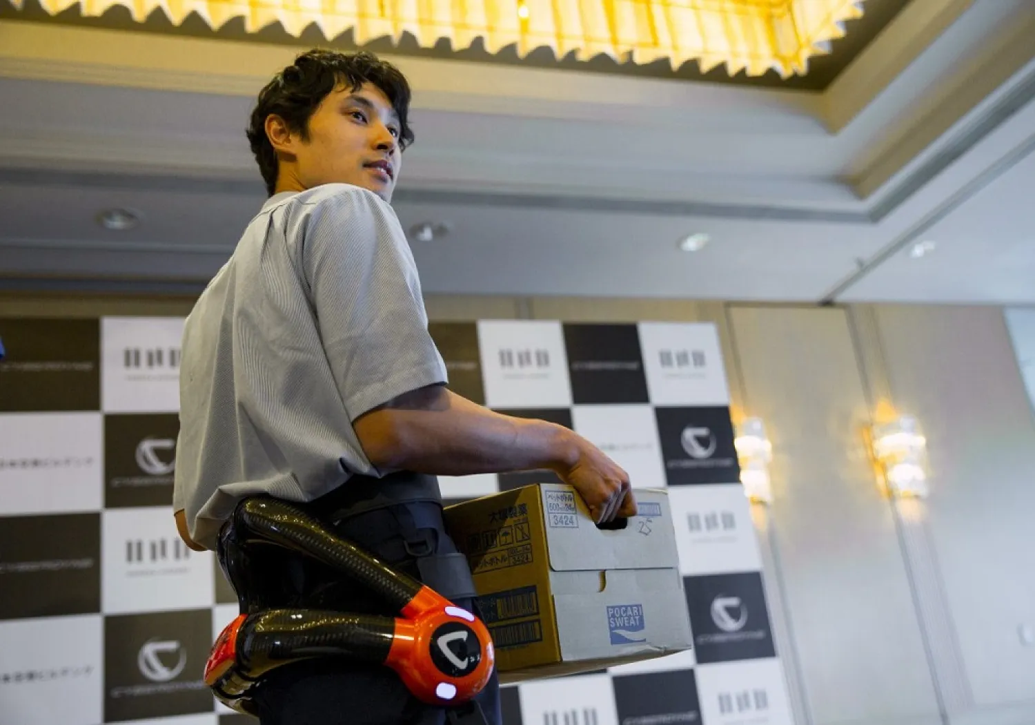 A man wears the new HAL device during a presentation at Haneda airport. (Reuters)