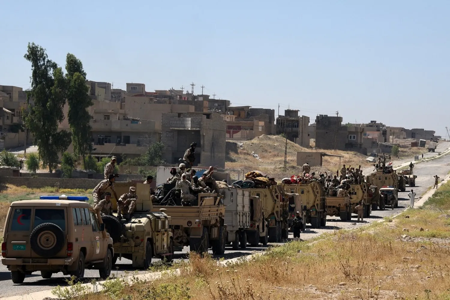 Iraqi government forces drive on a road leading to Talaafar on June 9, 2017, during ongoing battles to retake the city from ISIS militants. (AFP)