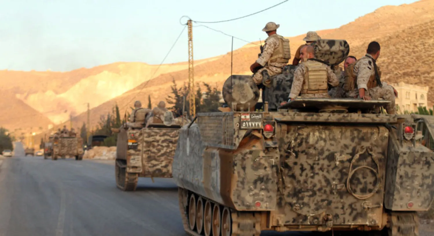 Lebanese army's armored personal carriers (APC) drive to the entrance of the town of Arsal in the Bekaa valley by the Syrian border on August 2, 2014. AFP PHOTO