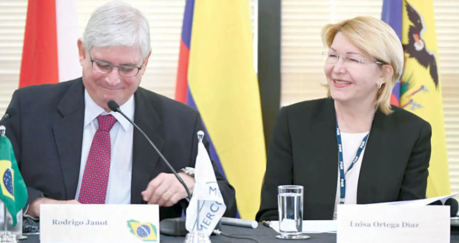 النائبة العامة الفنزويلية المعزولة بجانب النائب العام البرازيلي بعد وصولها إلى برازيليا (أ.ف.ب)