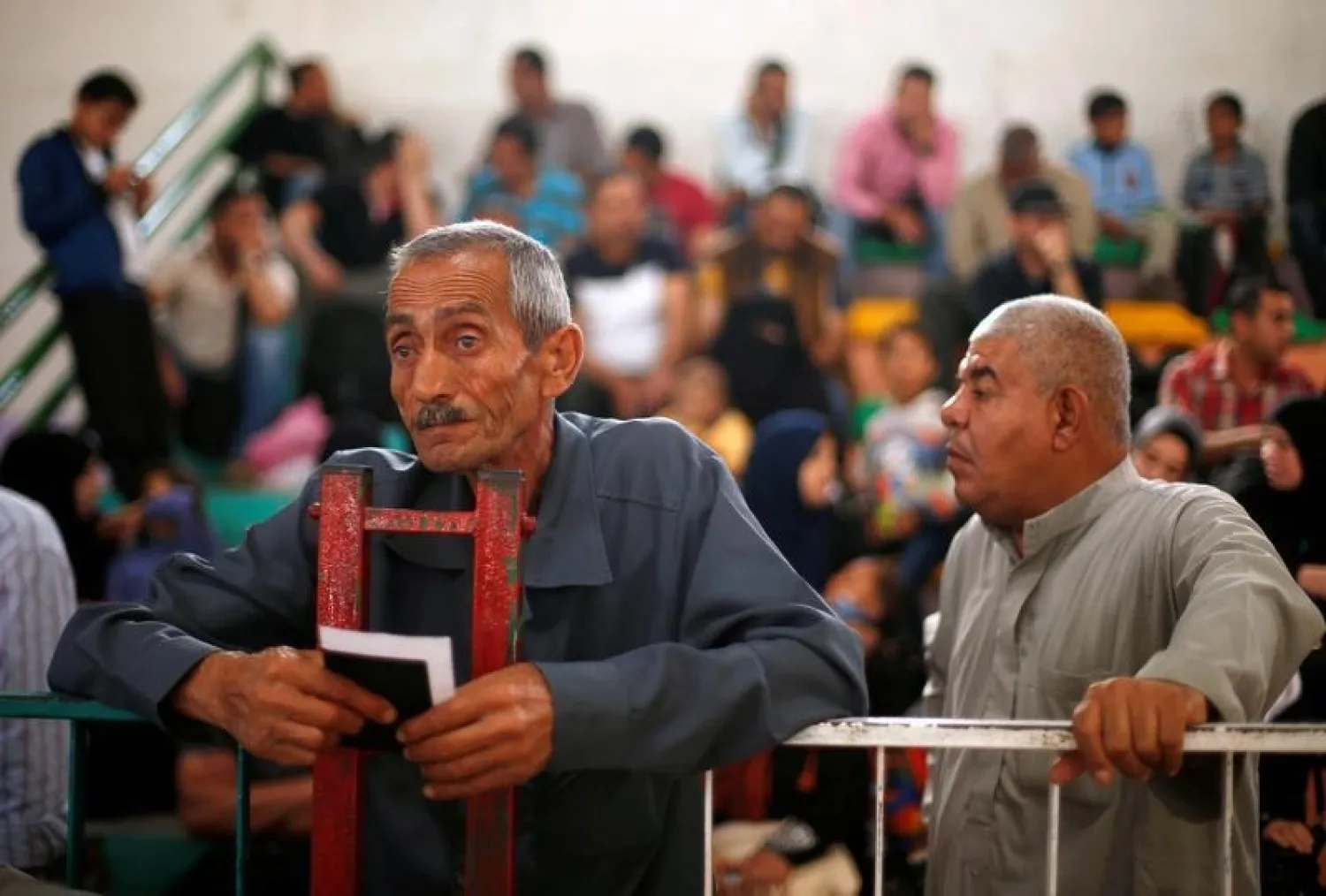 A man holds his document as he waits for a travel permit to cross into Egypt through the Rafah border crossing. (Reuters)
