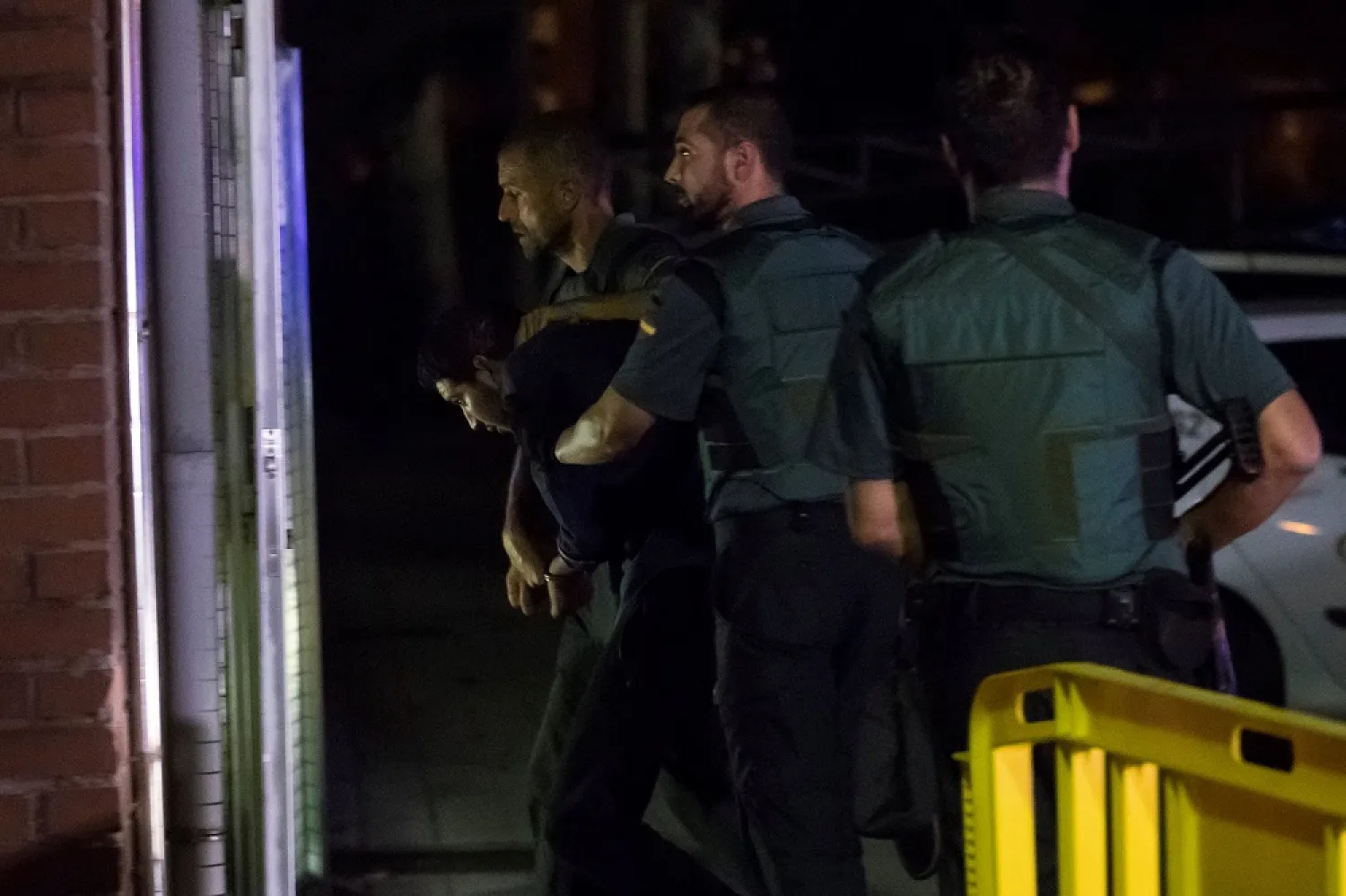 Spanish Civil Guards escort one of the four suspects of a militant cell behind last week’s Barcelona van attack. (Reuters)
