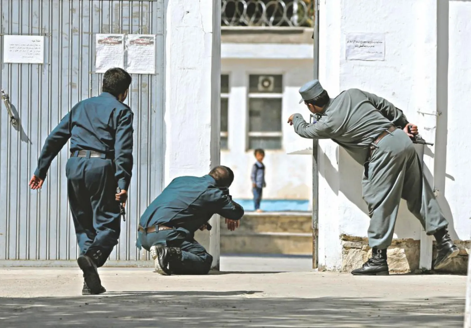 Policemen try to rescue a child at the site of a suicide attack on a mosque in Kabul. Photo: Reuters 