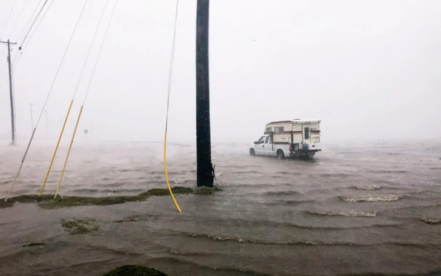 Craig "Cajun" Uggen, 57, nearly floods his truck as Hurricane Harvey comes ashore in Corpus Christi, Texas, US August 25, 2017. Minutes later, high winds blew off the camper carrying all of his belongings.  REUTERS/Brian Thevenot