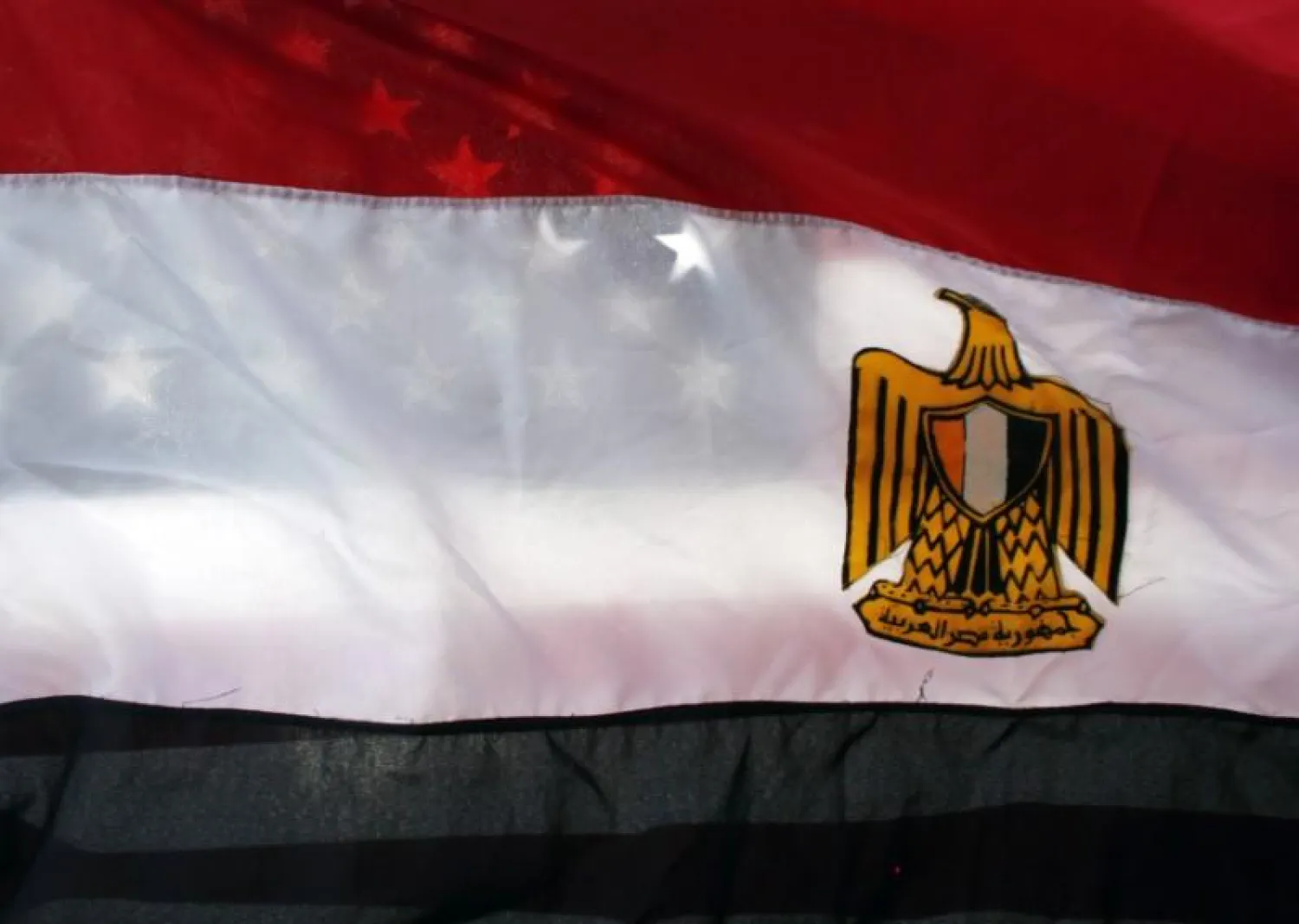 An American flag is seen behind an Egyptian flag in Westwood, California, January 29, 2011. REUTERS/Eric Thayer