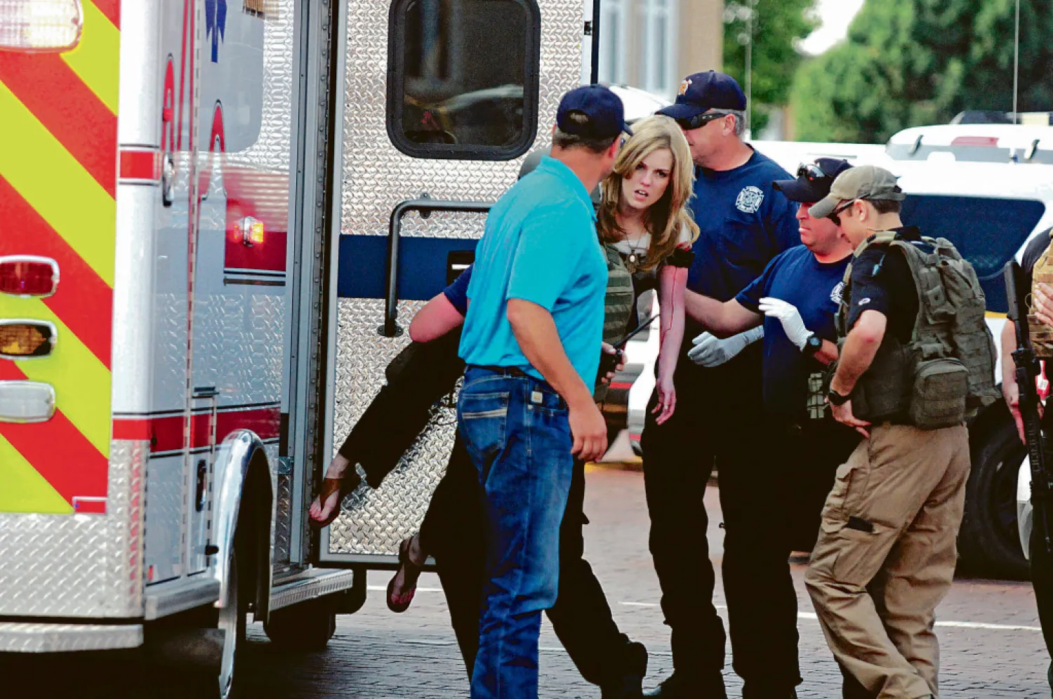 An injured woman is carried to an ambulance in Clovis, New Mexico as authorities respond to reports of a shooting inside a public library. (AP)