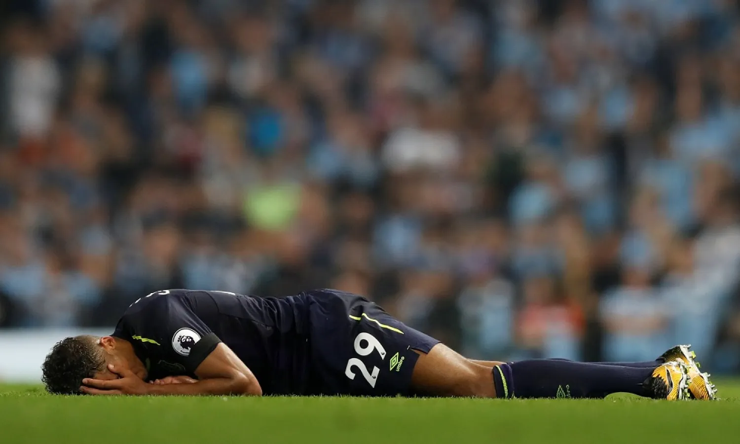 Everton’s Dominic Calvert-Lewin lies on the ground after a coming together with Manchester City’s Kyle Walker, who was shown a second yellow card for the incident. (Reuters)