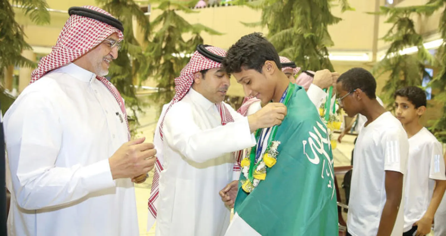 بطل التايكوندو السعودي محمد السويق متوشحاً بشعار الوطن خلال وصوله إلى الرياض («الشرق الأوسط»)