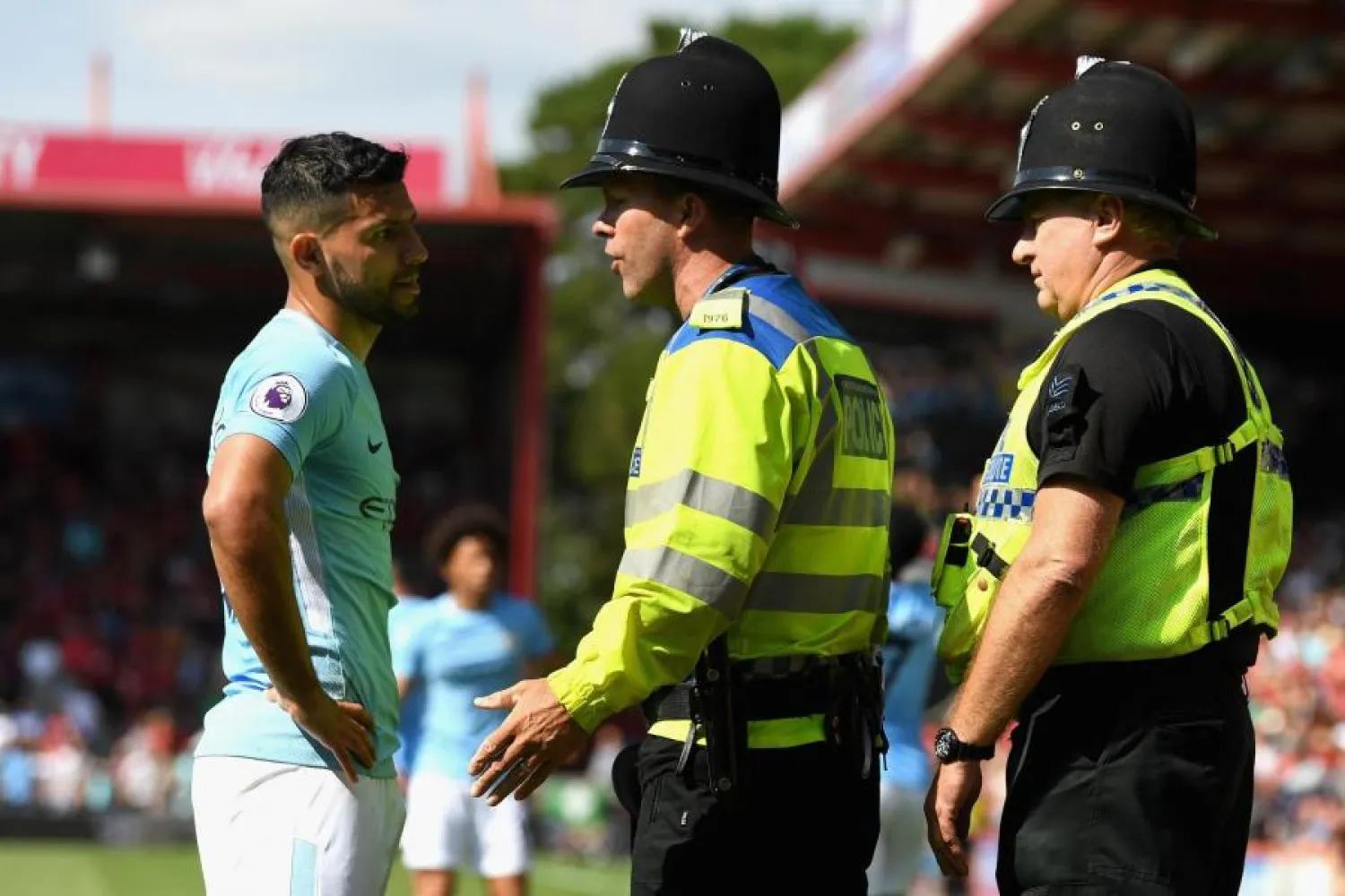 Manchester City striker Sergio Aguero speaks to a police officer after a security incident during his club’s Premier League match against Bournemouth on August 26. (Getty Images)