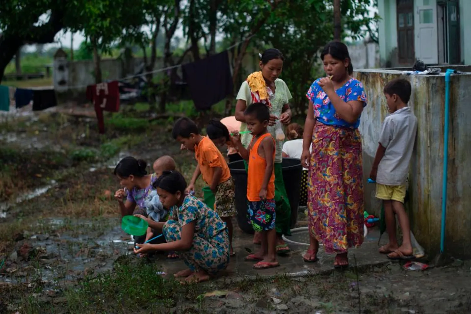 Rohingyas who escaped from unrest brush their teeth at a temporary shelter in Sittwe, Rakhine State on August 31, 2017. (Photo credit: STR/AFP/Getty Images)