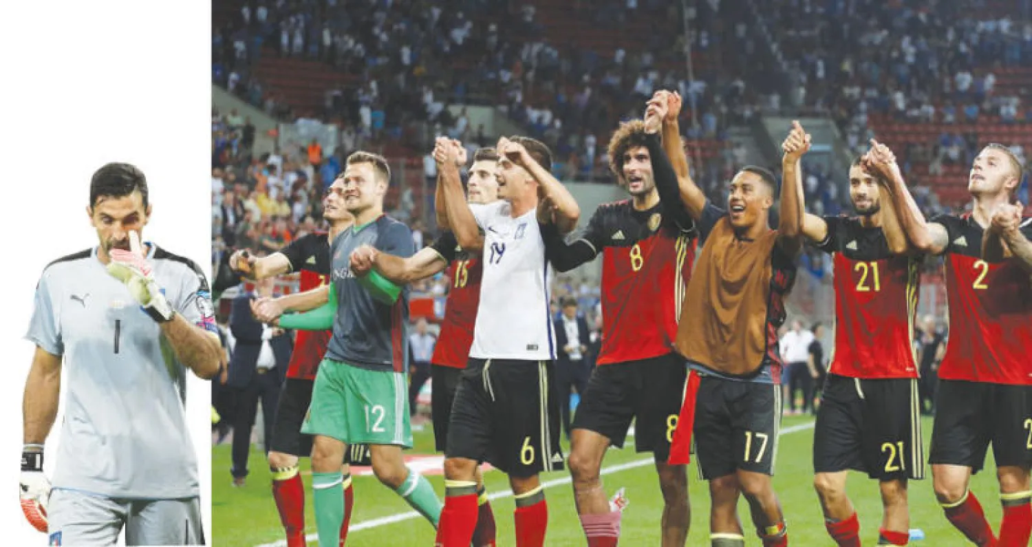لاعبو المنتخب البلجيكي يحتفلون بعد انتصارهم على اليونان وحصد بطاقة التأهل للمونديال (رويترز)  -  بوفون قائد إيطاليا تعرض لانتقادات ساخنة (أ.ف.ب)