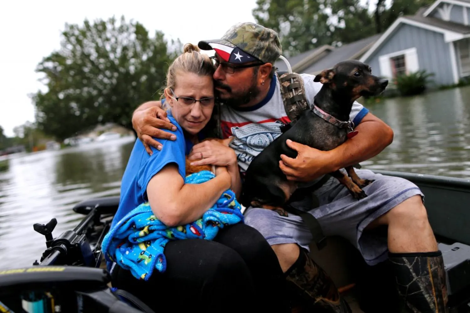 A flood survivor comforts his wife after being rescued from their home flooded by Hurricane Harvey in Orange, Texas, on August 30. (Reuters)