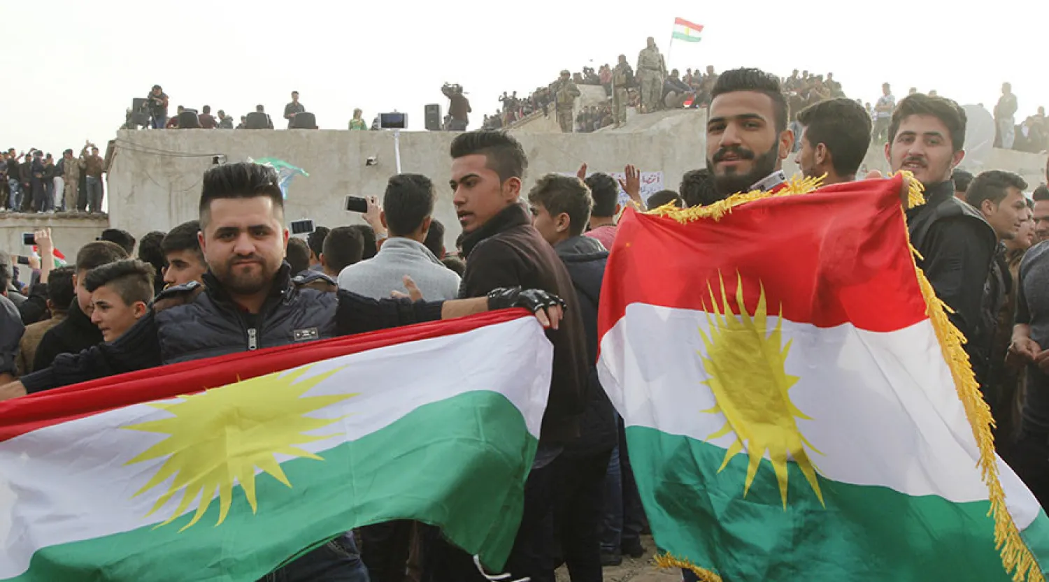 Kurdish residents hold flags during Norouz celebrations in Kirkuk, north of Baghdad. (Ako Rasheed / Reuters)