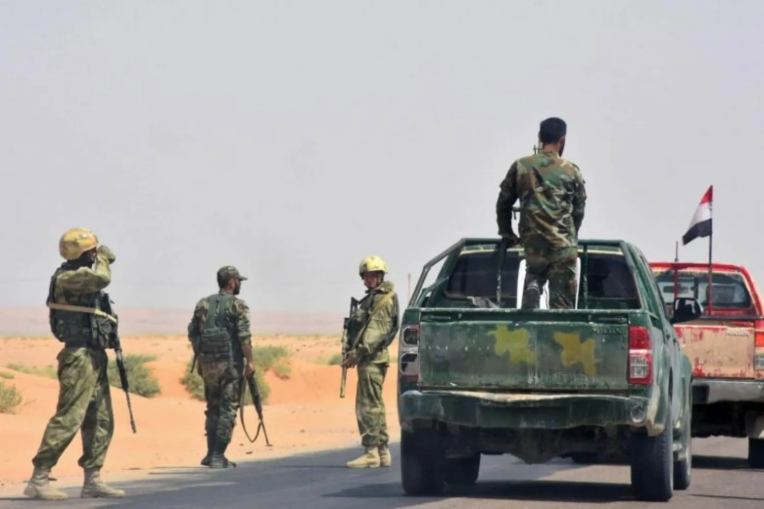 Syrian pro-regime forces gather on a road in Bir Qabaqib, more than 40 kilometers west of Deir Ezzor on Sept 4, 2017. PHOTO: AFP