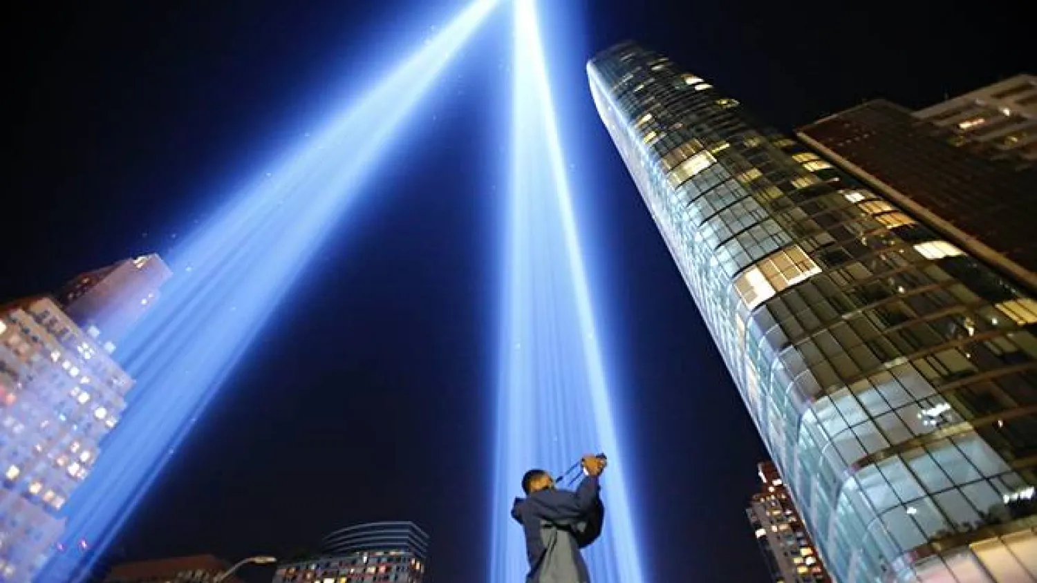 A man takes a picture as the Tribute in Light illuminates the New York City night sky on Sep 10, 2017, on the eve of the anniversary of the September 11, 2001 terror attacks. (Photo: AFP/ Kena Betancur)