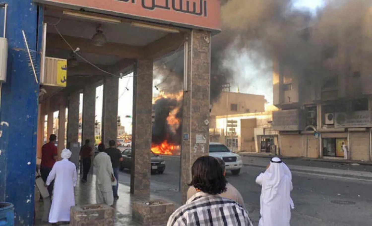 Bystanders watch as flames engulf a car explosion in Qatif neighborhood in the Eastern Province, Saudi Arabia, Photo shared by social media outlets.
 
