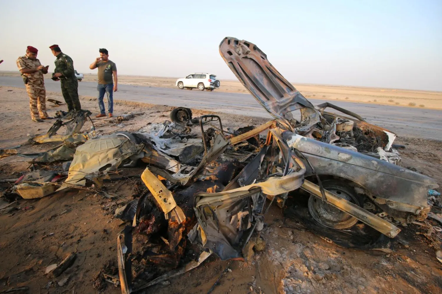 Iraqi security forces inspect the site of a bomb attack at a police checkpoint on a highway near the southern Iraqi city of Nassiriya, Iraq, September 14, 2017. REUTERS/Essam Al-Sudani