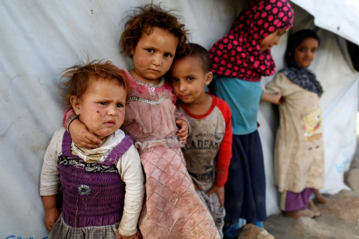 Children stand next to a tent at a camp for people displaced by the war near Sana’a, Yemen April 24, 2017. (Reuters)