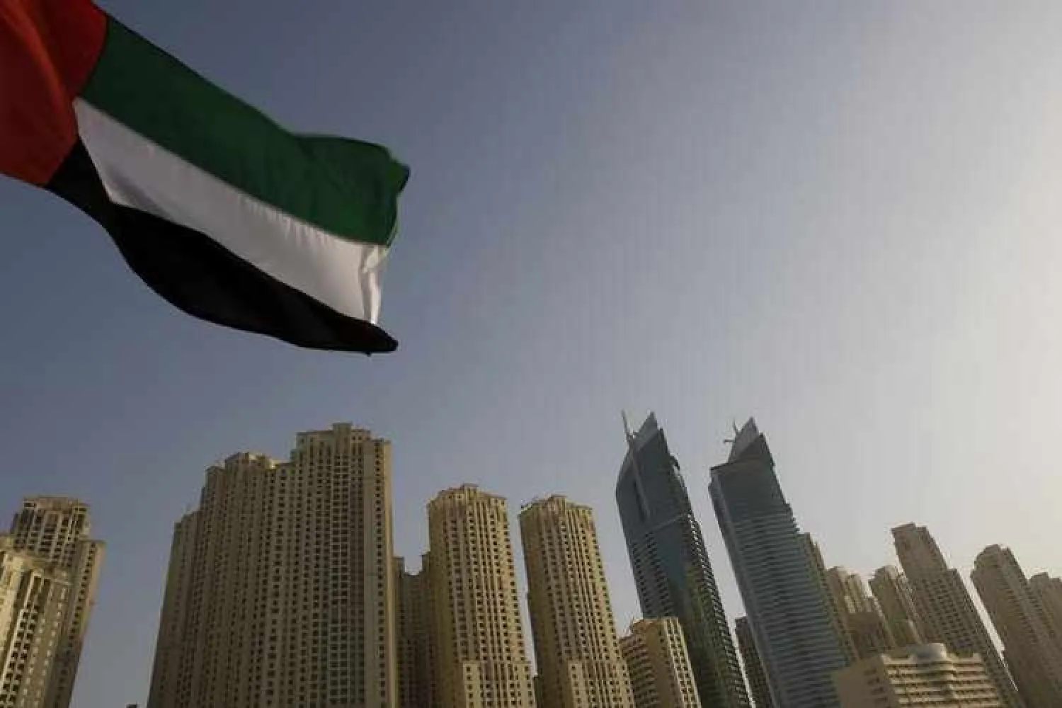 The United Arab Emirates flag flies in front of the Jumeirah Beach Residence in Dubai. Reuters
