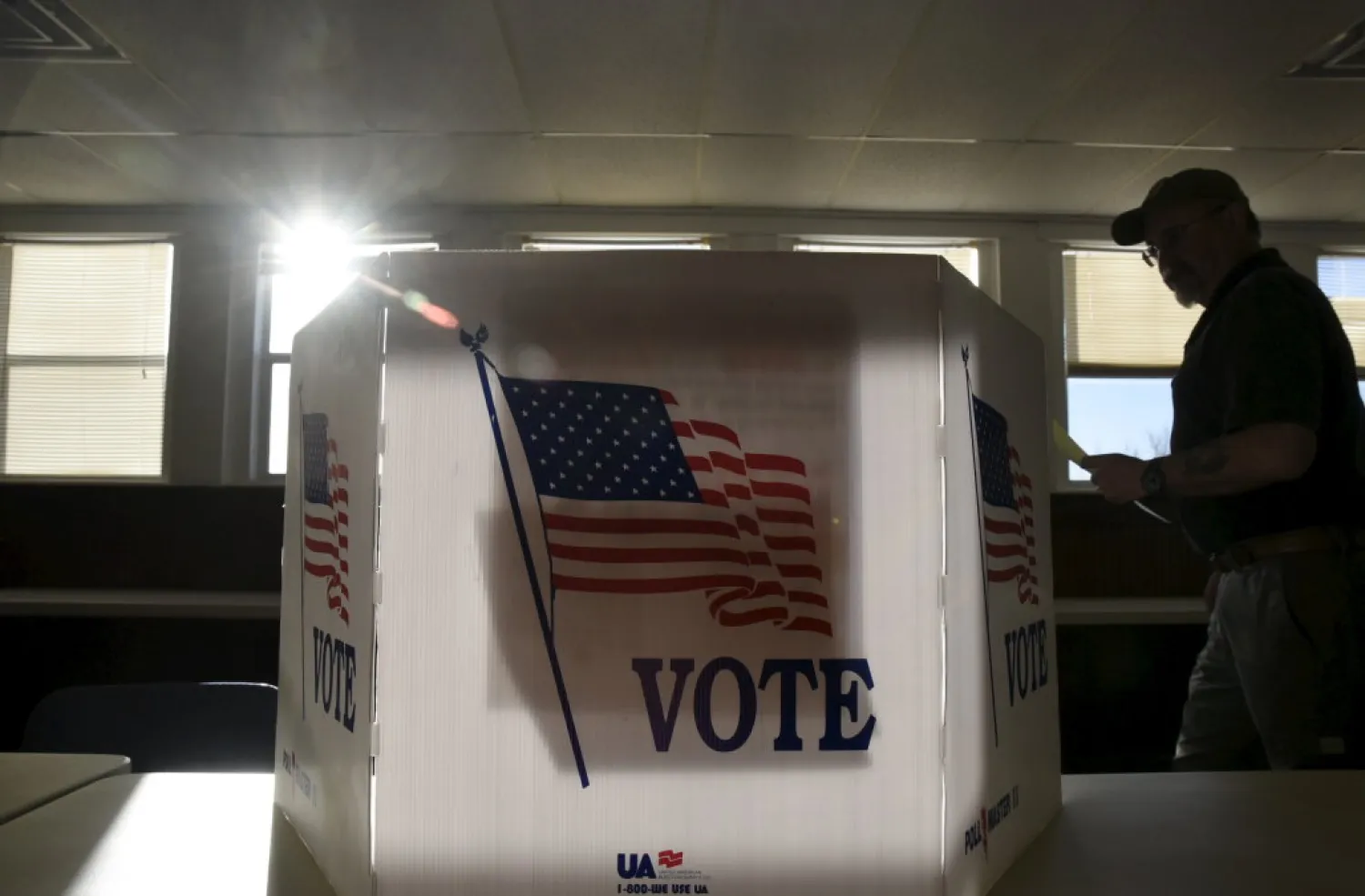 A voter heads to the booth to fill out his ballot at a polling site in Stillwater, Oklahoma, March 1, 2016. (Reuters)