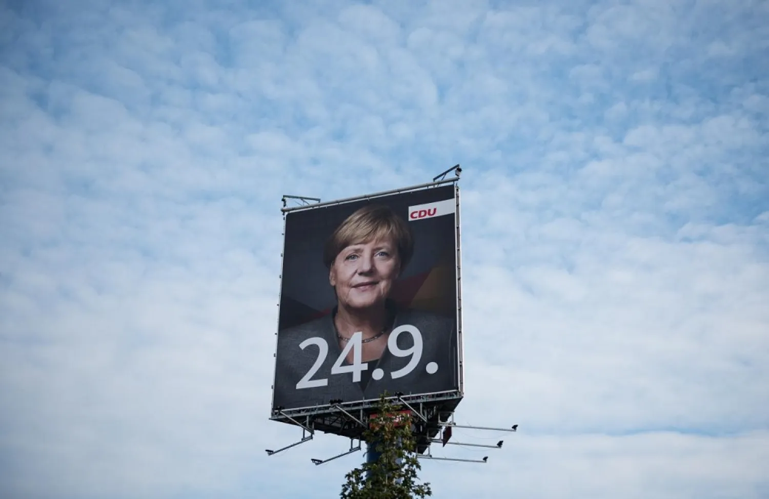 An election campaign poster for the general elections of the Christian Democratic Union party (CDU) with a headshot of German Chancellor Angela Merkel is displayed near Berlin, Germany. (Reuters)