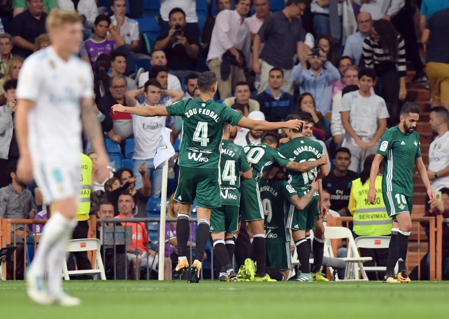Real Betis players celebrate a goal during the Spanish league football match against Real Madrid CF at the Santiago Bernabeu stadium in Madrid on September 20, 2017. (AFP)