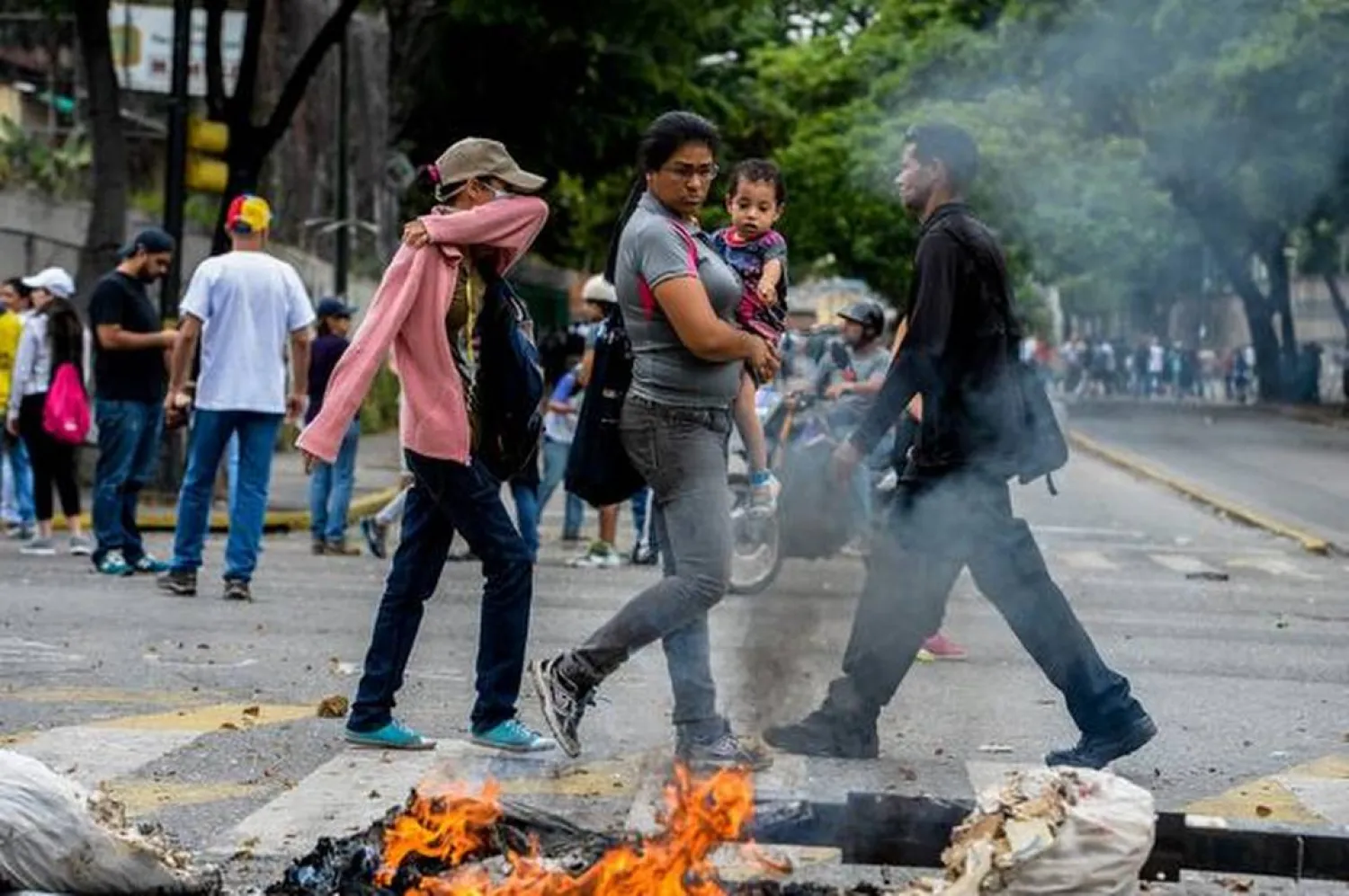 Demonstrators block a street during a protest against Venezuelan President Nicolas Maduro in Caracas on May 2, 2017. Photo Credit: AFP