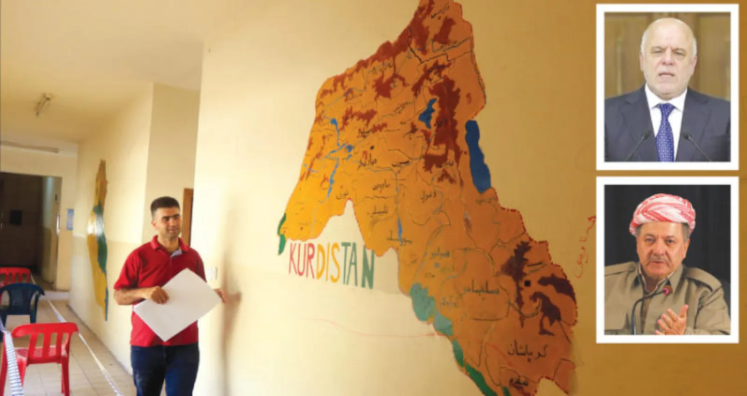 موظف انتخابي أمام خريطة تظهر توزّع الأكراد في أربع دول داخل مركز اقتراع في أربيل أمس (رويترز)... وفي الإطارين العبادي وبارزاني خلال حديثيهما أمس (أ.ف.ب) و (رويترز)