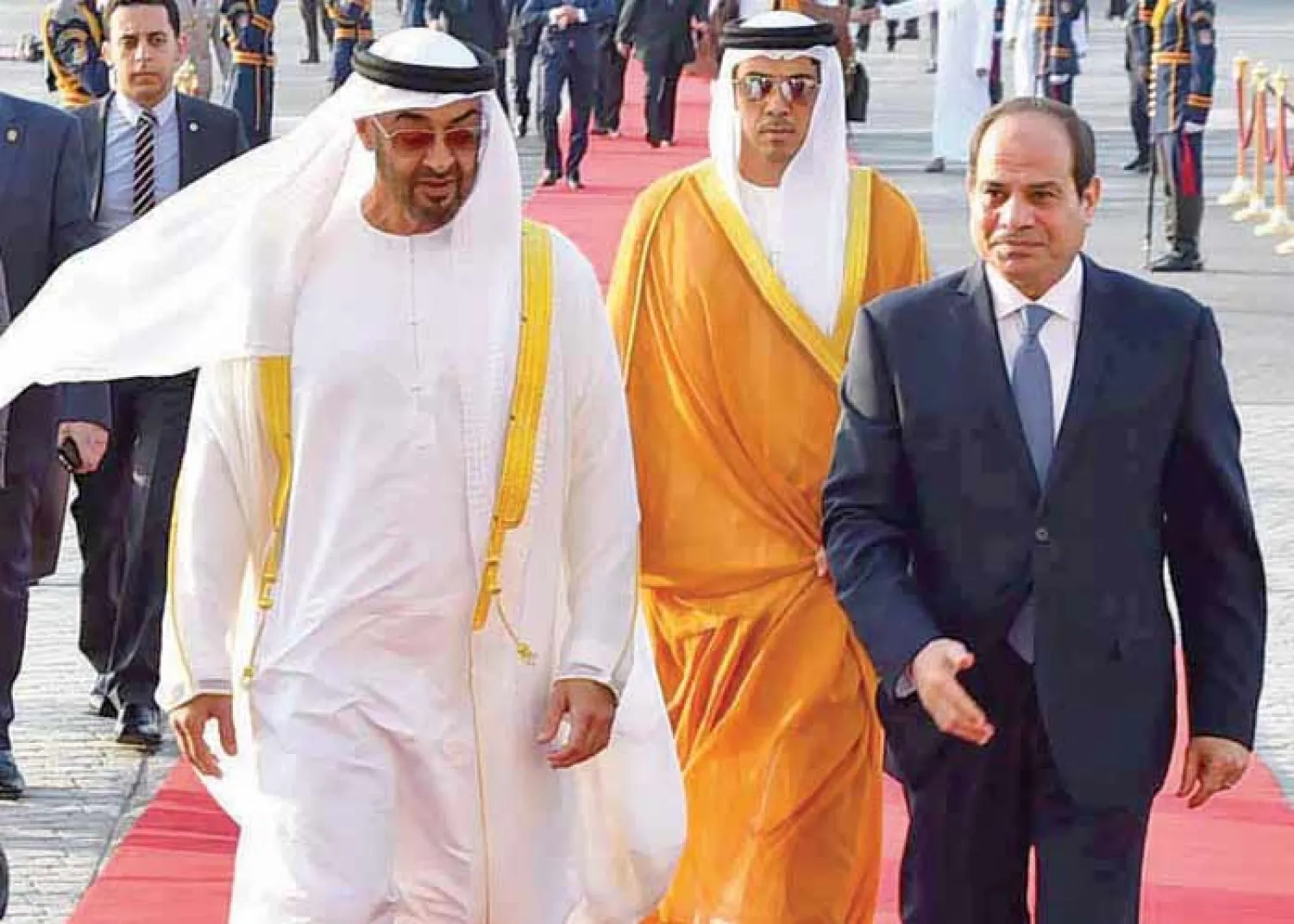 Egyptian President Abdel Fattah el-Sisi (R) walks with Abu Dhabi Crown Prince Sheikh Mohammed bin Zayed al-Nahyan after he arrives in Cairo International Airport, June 19. (Reuters)