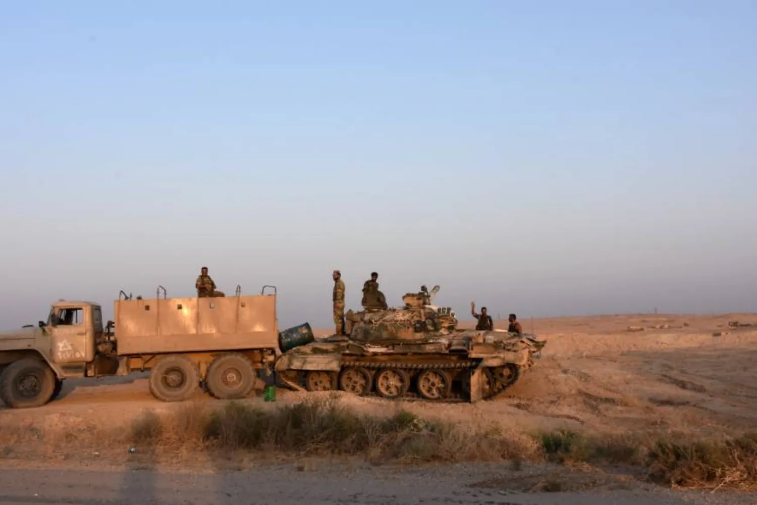  Syrian pro-government forces stand on a tank on the outskirts of the eastern city of Deir Ezzor. AFP