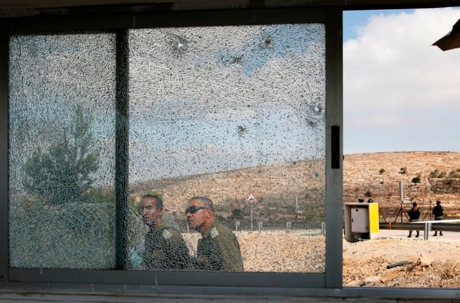 Bullet holes riddled an Israeli security post at the entrance to Har Adar, where a Palestinian man killed three Israelis on Tuesday before he was fatally shot. AFP