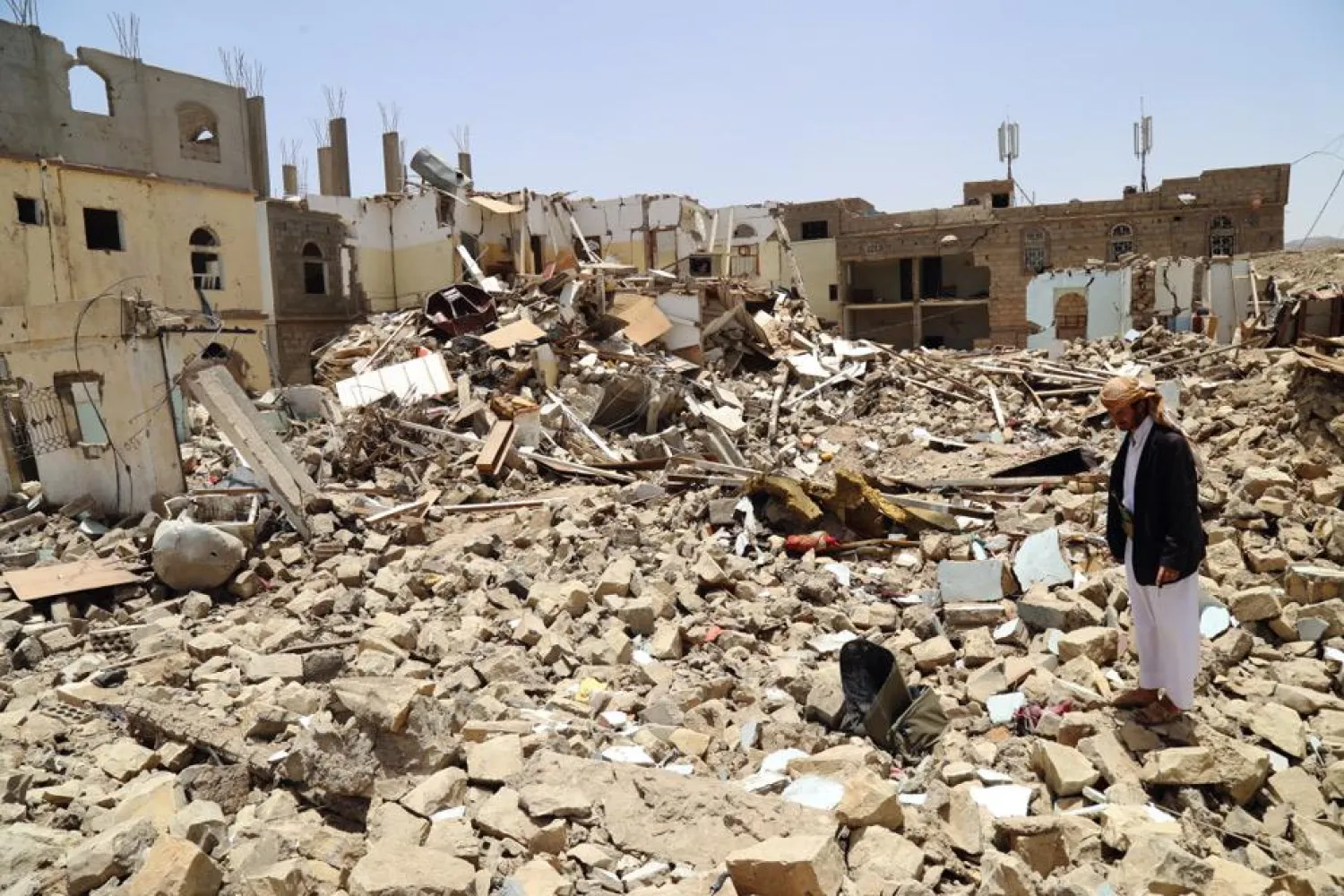 A man stands amid the rubble of the destroyed home. Human Rights Watch