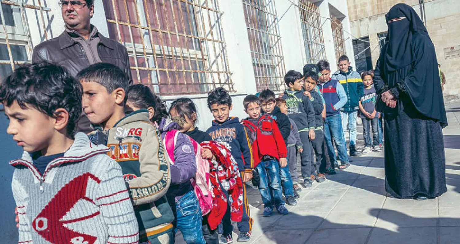 صورة أرشيفية لطلاب سوريين في مدرسة بمدينة الرمثا الأردنية شمال البلاد