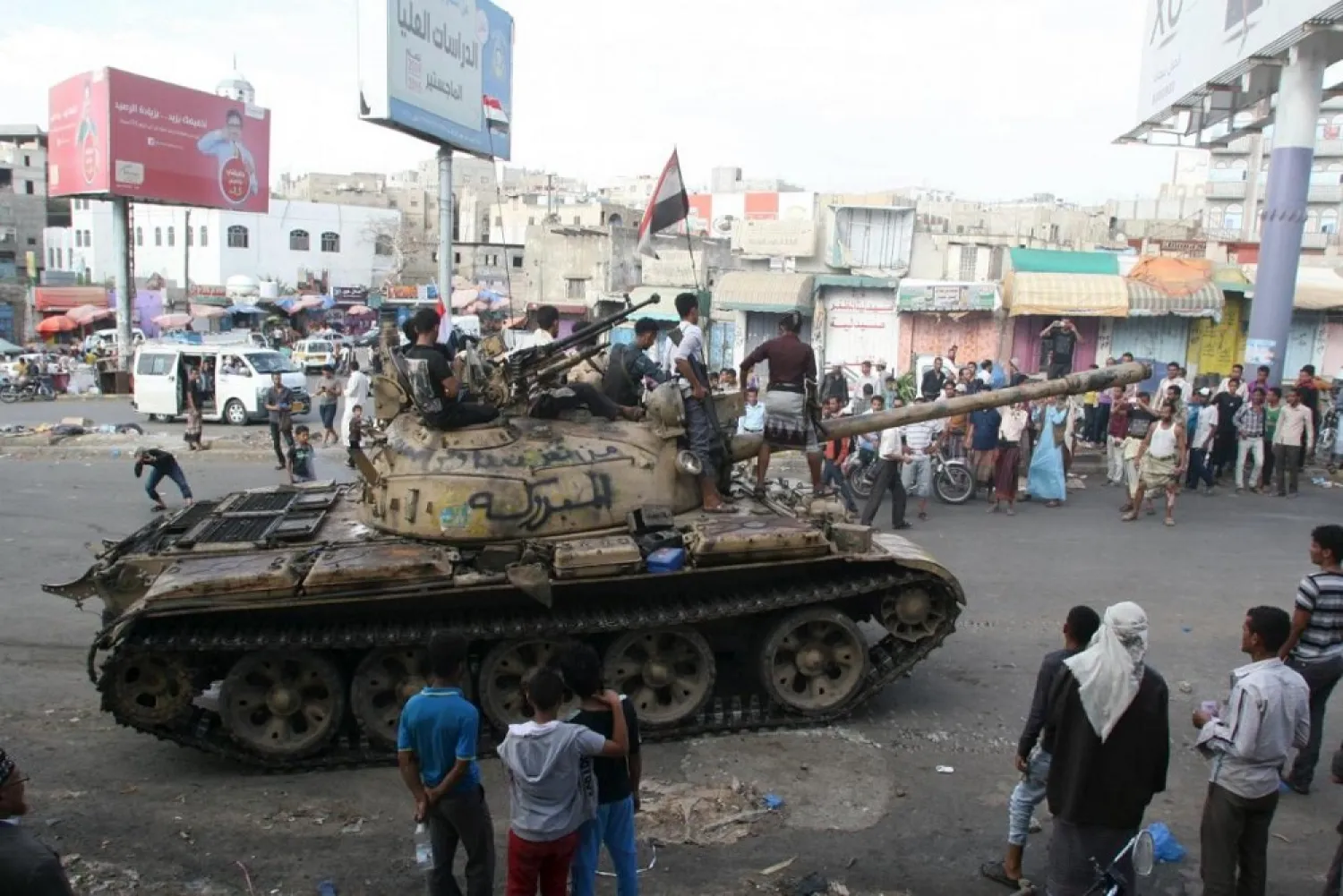 Pro-government fighters ride on a tank in the Bir Basha neighborhood after they took the area from Houthi fighters in Yemen's southwestern city of Taiz. (Reuters)