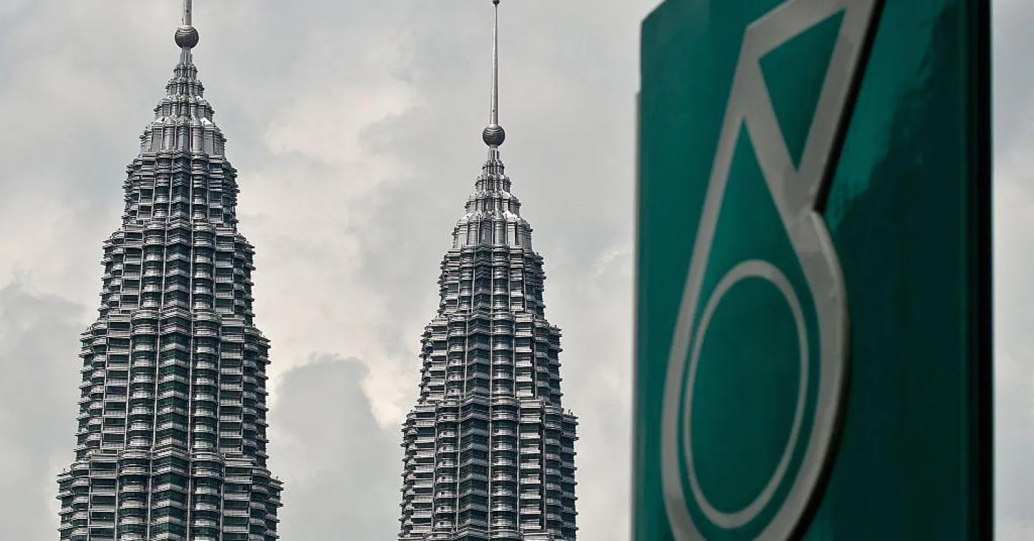 The logo of a Petronas fuel station is seen with the Petronas Twin Towers in the background in Kuala Lumpur, Malaysia. AFP