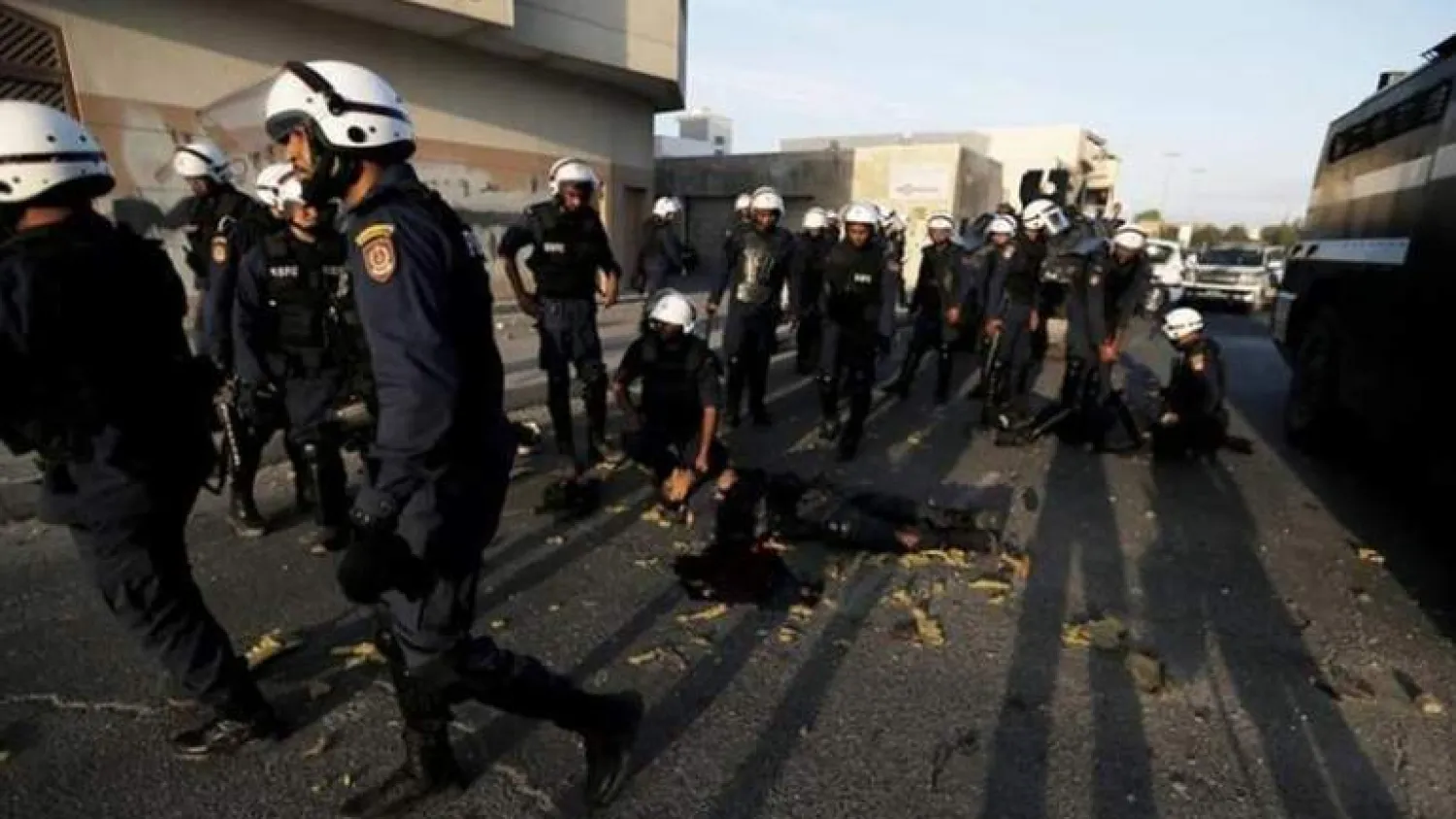 The body of a riot police officer lies on the road as other officers tend to him after a bomb exploded in 2014 (Reuters)
