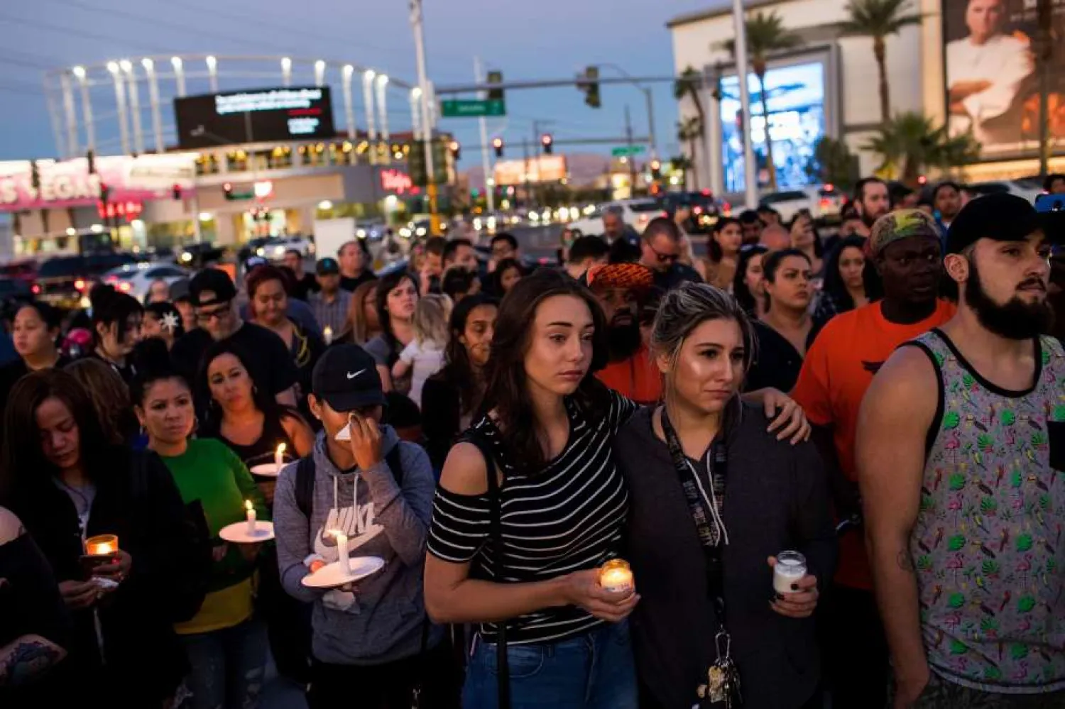 Mourners attend a candlelight vigil at the corner of Sahara Avenue and Las Vegas Boulevard for the victims of Sunday night's mass shooting in Las Vegas on October 2, 2017. (Getty Images)