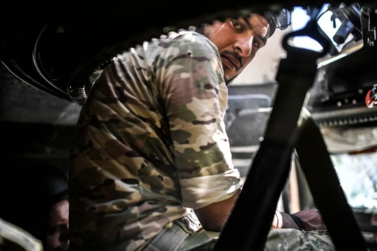 A member of the Syrian Democratic Forces sits inside a humvee during a battle against ISIS terrorists to retake the central hospital of Raqqa, September 28, 2017. (AFP)