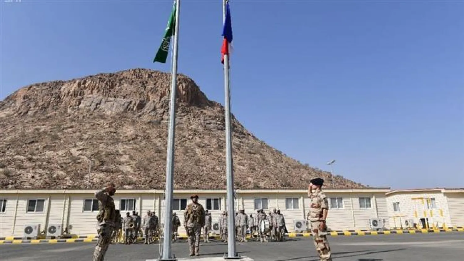 Saudi and French military personnel saluting the flags of the two countries in a military base in the city of Ta'if in southwestern Saudi Arabia on October 3, 2017. (SPA)