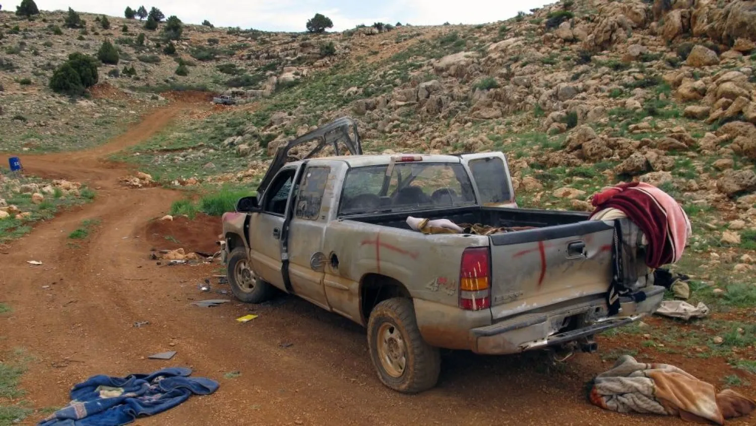 A damaged SUV left behind by members of al-Nusra Front in a position captured by Lebanon’s Hezbollah fighters in the fields of the Syrian border town of Assal al-Ward, May 9, 2015. AP/Bassem Mroue