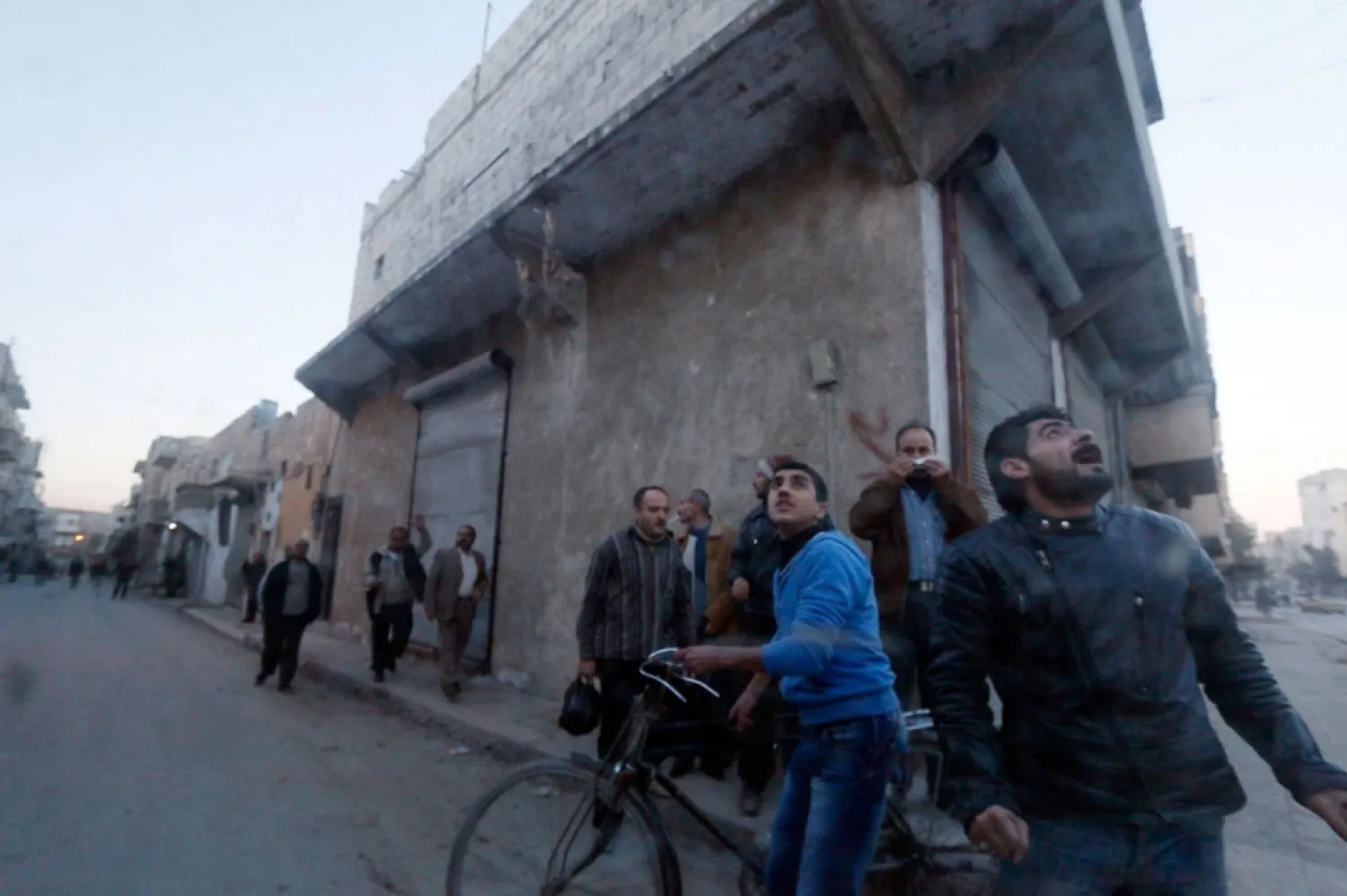  File Photo, Residents watch the skies during an air raid by forces loyal to Assad. Saad Abobrahim/Reuters