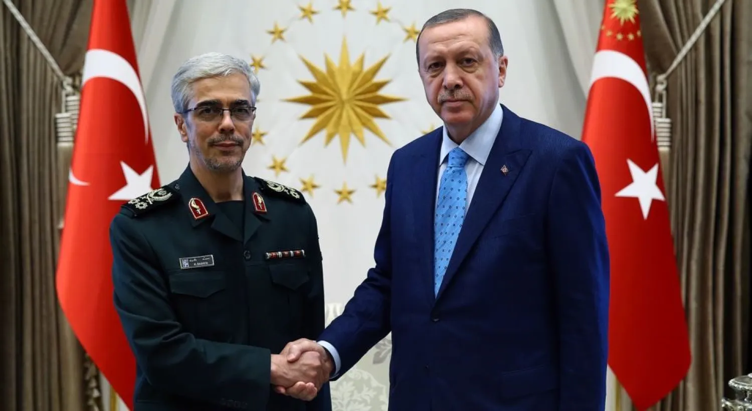 Turkish President Recep Tayyip Erdogan greets the chief of staff of Iran’s armed forces, Muhammad Hussein Baqeri, in Ankara on August 16. (Reuters)