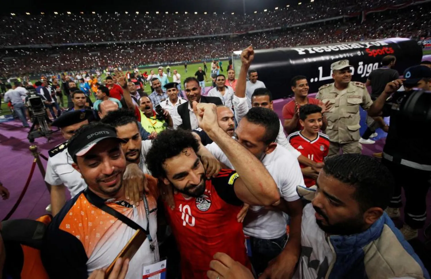 Egypt striker Mohammed Salah is mobbed by fans after he sealed his country's qualification for the 2018 World Cup. (Reuters)