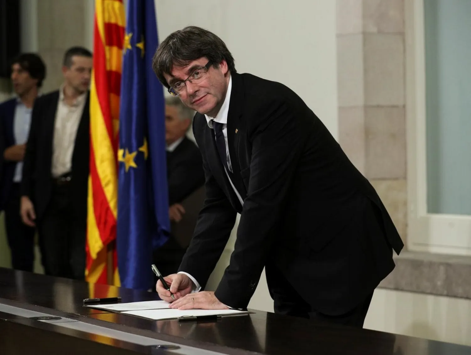 Catalan President Carles Puigdemont signs a declaration of independence at the Catalan regional parliament in Barcelona, Spain, October 10, 2017. (Reuters)