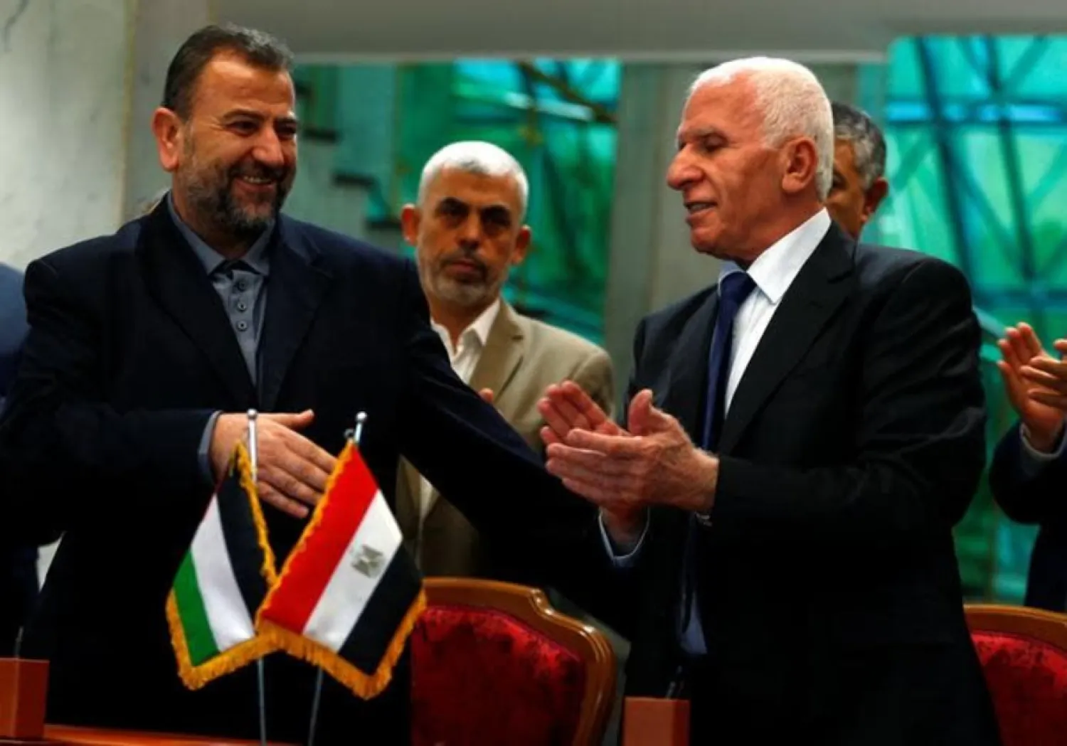 Head of Hamas delegation Saleh Arouri and Fatah leader Azzam al-Ahmad sign a reconciliation deal in Cairo, Egypt, October 12, 2017 (photo credit: REUTERS/AMR ABDALLAH DALSH
