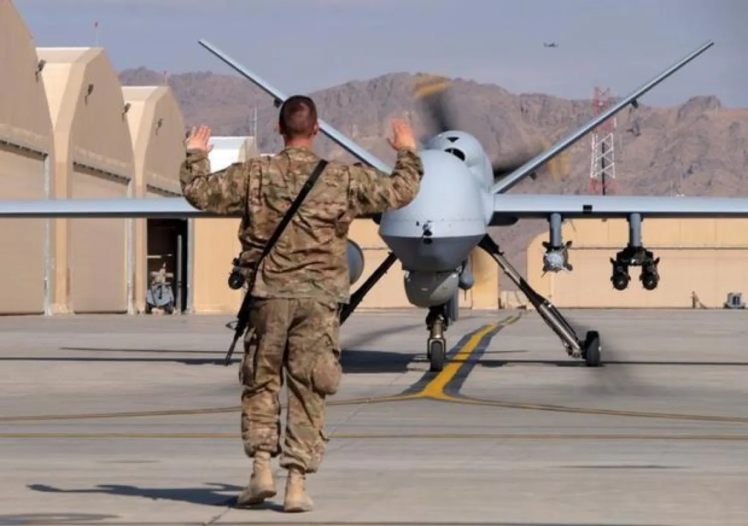 A US airman guides a US Air Force MQ-9 Reaper drone as it taxis to the runway at Kandahar Airfield, Afghanistan March 9, 2016. REUTERS/Josh Smith/Files