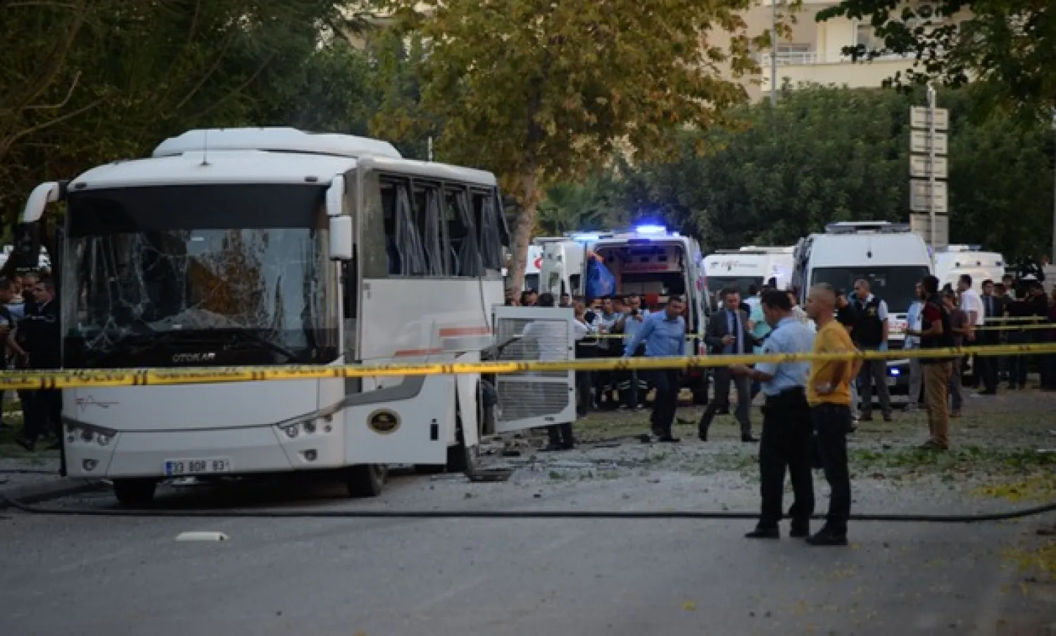 Plainclothes police officers stand after a bomb hit a bus carrying police officers in Mersin, Turkey, October 17, 2017. REUTERS 