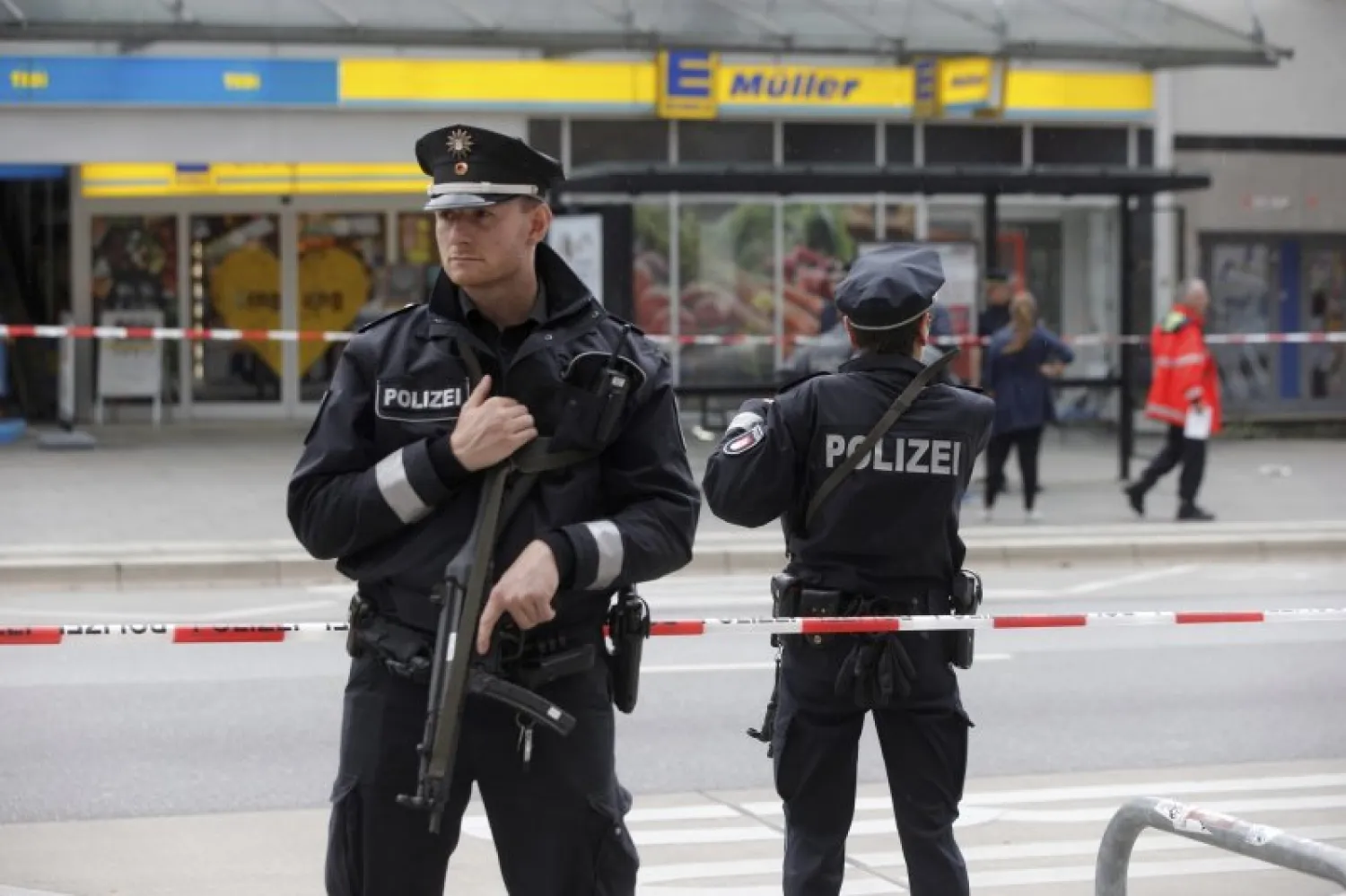 Police officers secure the area after a knife attack at a supermarket in Hamburg, Germany. AP file photo