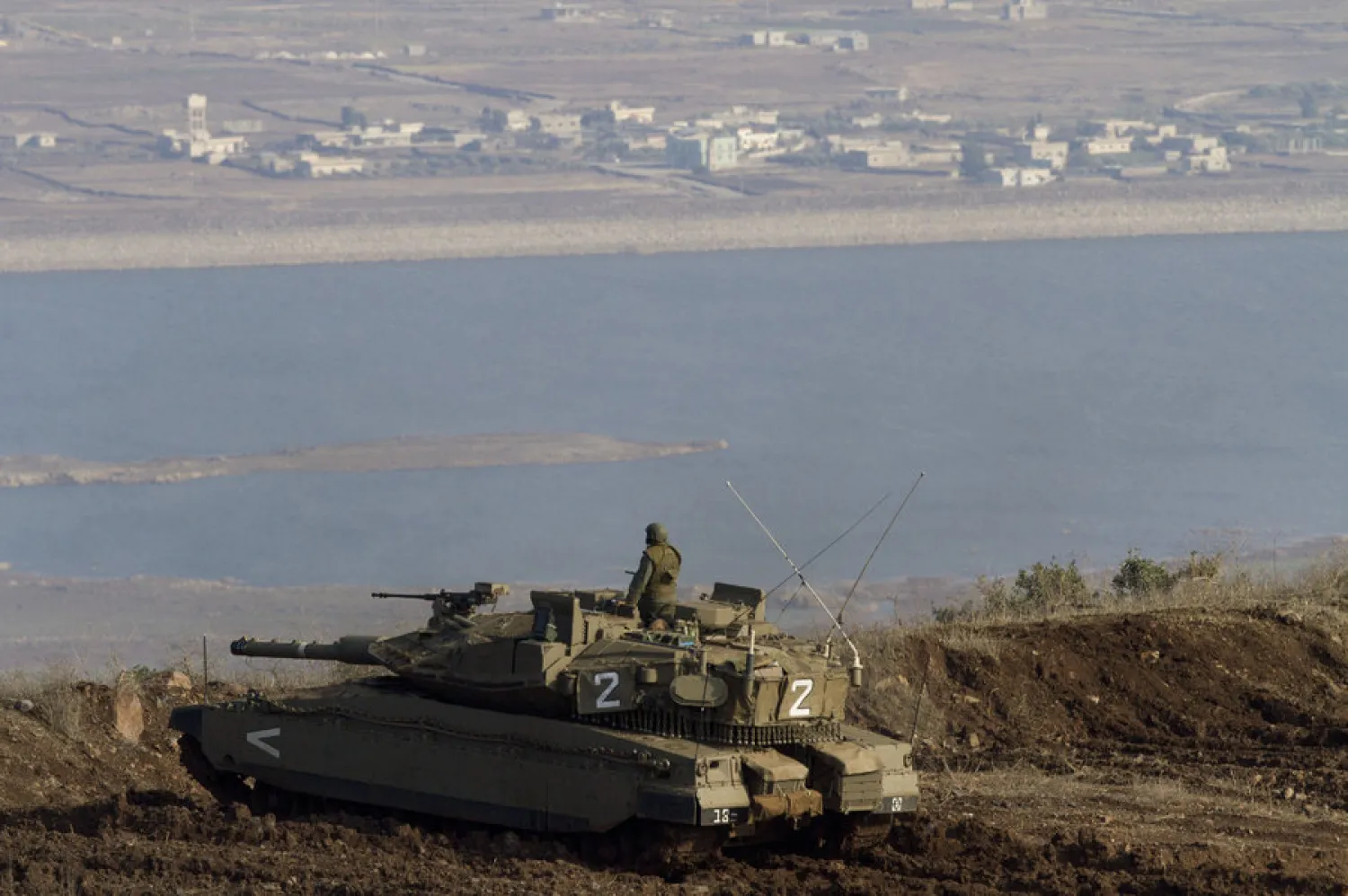 File photo: An Israeli tank in the Golan Heights overlooks the Syrian village of Bariqa. Ariel Schalit/AP