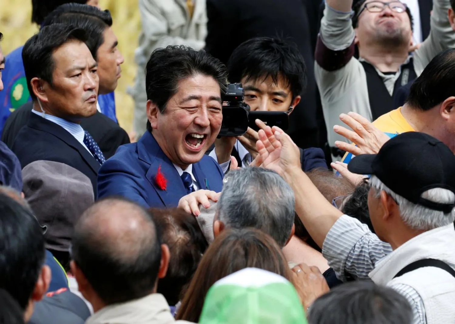 Japan's Prime Minister Shinzo Abe, who is also ruling Liberal Democratic Party leader, shakes hands with his supporters after an election campaign rally in Fukushima, Japan, October 10, 2017. (Reuters)